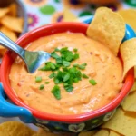 Bowl of Rotel dip served with tortilla chips, ideal for gatherings.